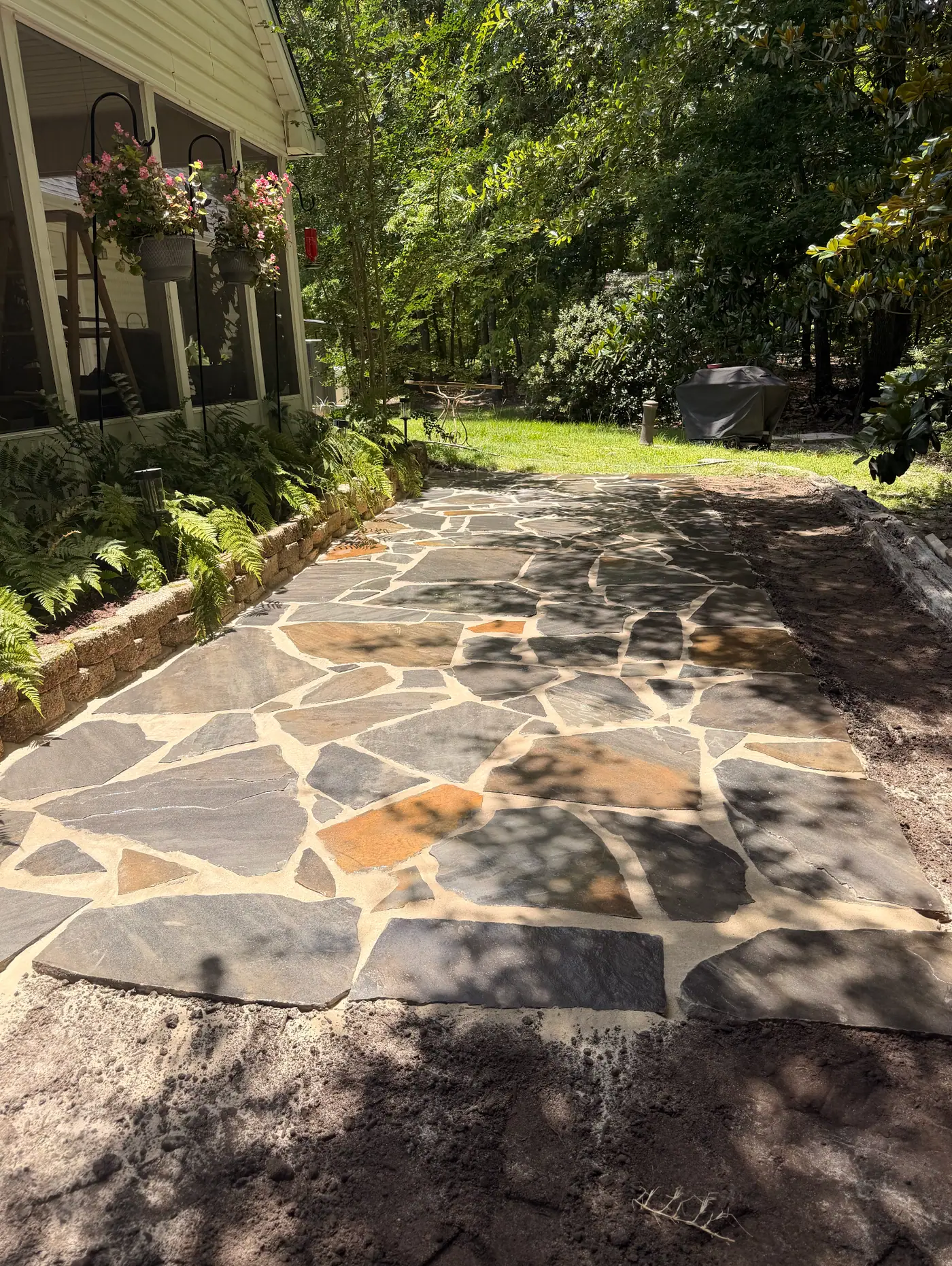 Hall flagstone patio beside the screened porch after installation